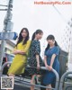 A group of young women standing next to each other on a street.