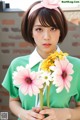 A woman holding a bunch of flowers in her hands.